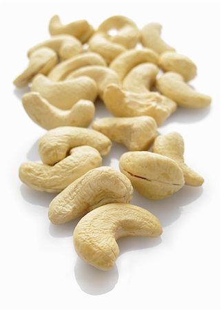 Cashew nuts on a white surface Stock Photo - Premium Royalty-Free, Code: 659-06153948