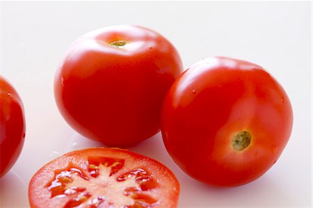 simsearch:659-07069748,k - Whole tomatoes and a tomato slice Foto de stock - Sin royalties Premium, Código: 659-06184074