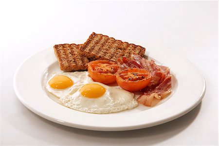 english cuisine - English breakfast (fried egg, bacon, wholemeal toast, tomatoes) Stock Photo - Premium Royalty-Free, Code: 659-06184073