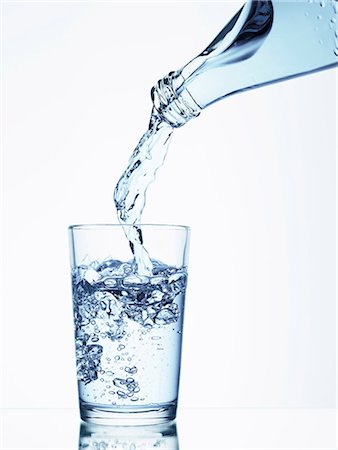 Pouring water from a bottle into a glass Stock Photo - Premium Royalty-Free, Code: 659-06184175