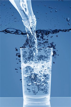 pouring water stream - Pouring water from a bottle into a glass Stock Photo - Premium Royalty-Free, Code: 659-06184172