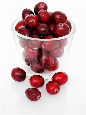 Cranberries in a glass bowl and next to it Stock Photo - Premium Royalty-Free, Code: 659-06184386