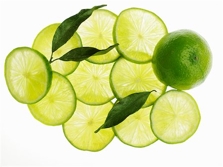 A whole lime, lime slice and lime leaves Stock Photo - Premium Royalty-Free, Code: 659-06184401