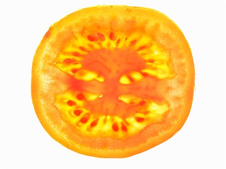 simsearch:659-07598077,k - A tomato slice, lit from behind Fotografie stock - Premium Royalty-Free, Codice: 659-06184411