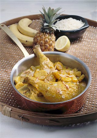 simsearch:659-01848366,k - Chicken legs in curry sauce with banana, pineapple, almonds Foto de stock - Royalty Free Premium, Número: 659-06184478
