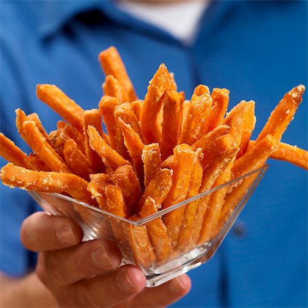 Man Holding a Glass Bowl of Sweet Potato Fries Stock Photo - Premium Royalty-Free, Code: 659-06184671