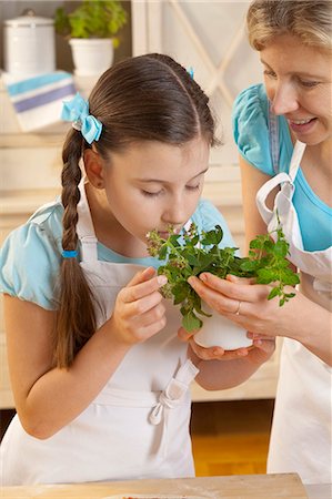 Mother and daughter with fresh herbs in kitchen Stock Photo - Premium Royalty-Free, Code: 659-06185377