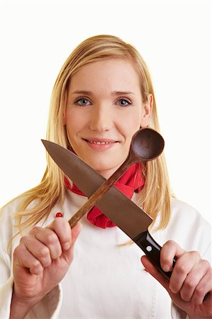 Female chef holding crossed kitchen knife and wooden spoon Foto de stock - Sin royalties Premium, Código: 659-06185442