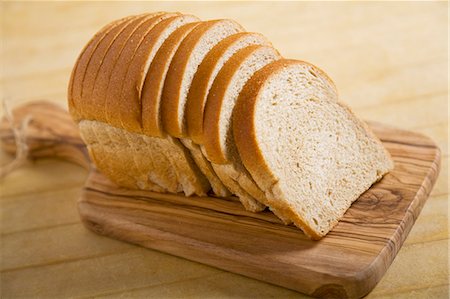 Loaf of Sliced Wheat Bread on Cutting Board Foto de stock - Sin royalties Premium, Código: 659-06185495
