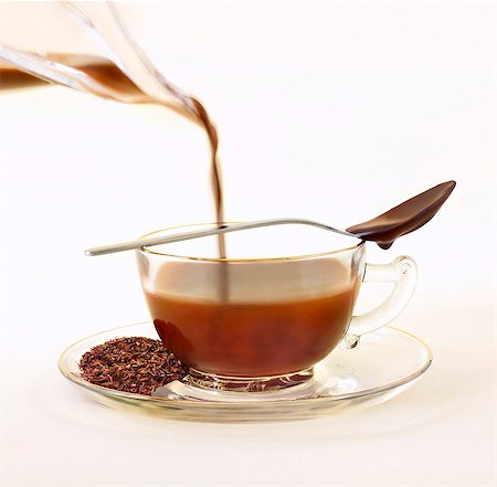 food photography chocolate pouring - Cocoa Infused Tea; Chocolate Infused Rooibos Tea with Loose Tea Leaves on Saucer; Chocolate Spoon Stock Photo - Premium Royalty-Free, Code: 659-06185851