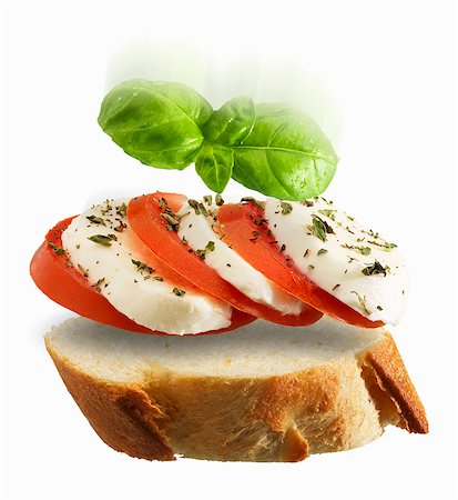 simsearch:659-06495587,k - A slice of baguette topped with tomato, mozzarella and basil Foto de stock - Sin royalties Premium, Código: 659-06186040