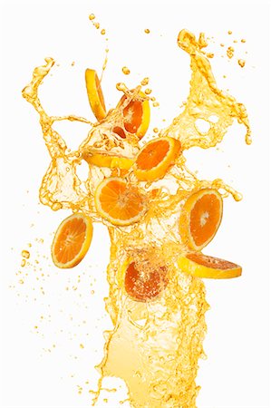 salir a chorros - Orange slices and a splash of orange juice Foto de stock - Sin royalties Premium, Código: 659-06186050