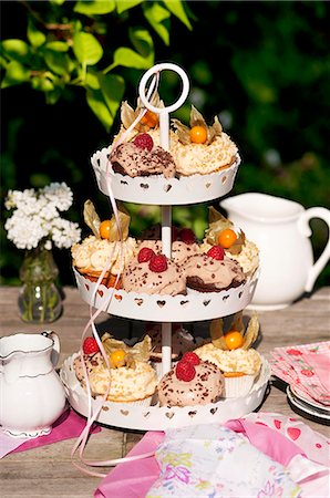set - Various cupcakes on a cake stand on a garden table Stock Photo - Premium Royalty-Free, Code: 659-06186072