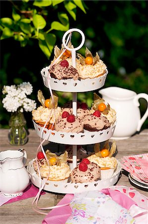 food and drinks on table - Various cupcakes on a cake stand on a garden table Stock Photo - Premium Royalty-Free, Code: 659-06186072