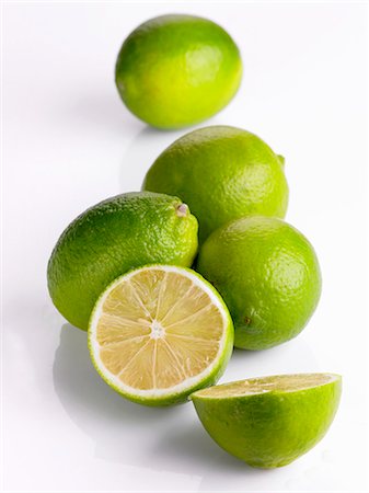 Several limes, whole and halved Fotografie stock - Premium Royalty-Free, Codice: 659-06186129