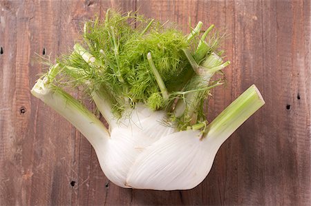 A fennel bulb on a wooden surface Stock Photo - Premium Royalty-Free, Code: 659-06186303