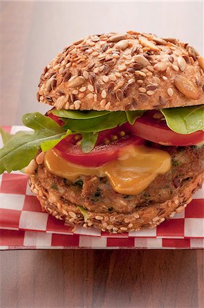 simsearch:659-06495069,k - A burger with mustard, tomatoes and rocket Stock Photo - Premium Royalty-Free, Code: 659-06186358