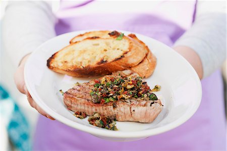 simsearch:659-06903102,k - A person holding a plate of steak and bread Stock Photo - Premium Royalty-Free, Code: 659-06186385