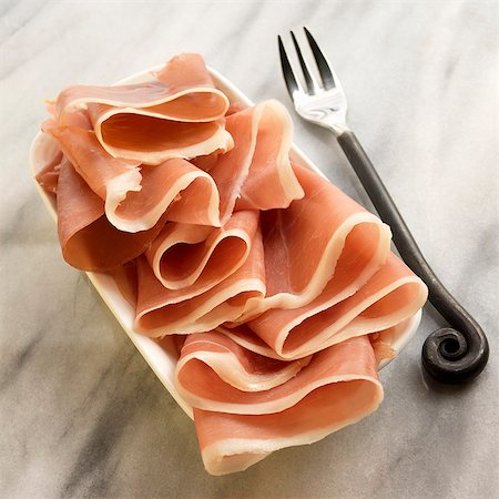 Jamon Serrano Ham on a Dish; Fork Stock Photo - Premium Royalty-Free, Code: 659-06186456