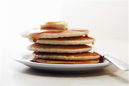 Pile of pancakes with maple syrup and butter Stock Photo - Premium Royalty-Free, Code: 659-06186509