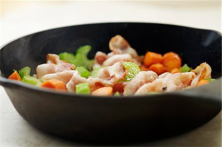 pan frying - Bacon, Carrots and Celery in a Cast Iron Skillet Stock Photo - Premium Royalty-Free, Code: 659-06186501