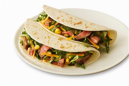 Two Beef Soft Tacos on a White Plate; White Background Stock Photo - Premium Royalty-Free, Code: 659-06186564