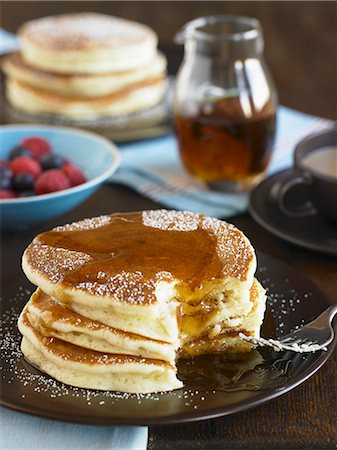 simsearch:659-01854693,k - Stack of Buttermilk Pancakes with Syrup and Powdered Sugar; Bite Taken Out Fotografie stock - Premium Royalty-Free, Codice: 659-06186604