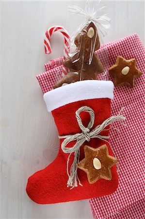 A Christmas stocking, candy canes, gingerbread and checked cloth Stock Photo - Premium Royalty-Free, Code: 659-06186733