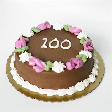 Chocolate Frosted Birthday Cake with the Number 100 On It Stock Photo - Premium Royalty-Free, Code: 659-06186815
