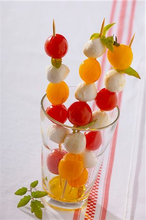 Cherry tomatoes, mozzarella and basil on sticks Stock Photo - Premium Royalty-Free, Code: 659-06187051