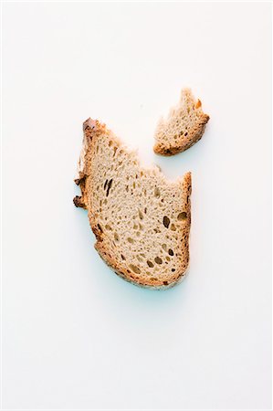 simsearch:659-08512915,k - A slice of bread with a bite taken out Stock Photo - Premium Royalty-Free, Code: 659-06187062