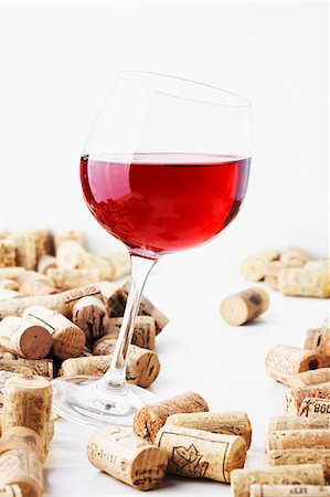 A glass of red wine with corks Stock Photo - Premium Royalty-Free, Code: 659-06187189