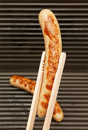 simsearch:659-07958279,k - A sausage being held with tongs Stock Photo - Premium Royalty-Free, Code: 659-06187224