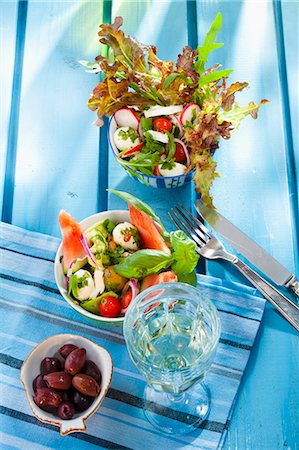 Two summer salads, olives and a glass of white wine Stock Photo - Premium Royalty-Free, Code: 659-06187291