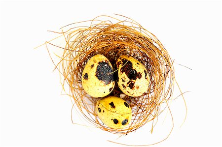 Three quail's eggs in a nest (seen from above) Fotografie stock - Premium Royalty-Free, Codice: 659-06187318