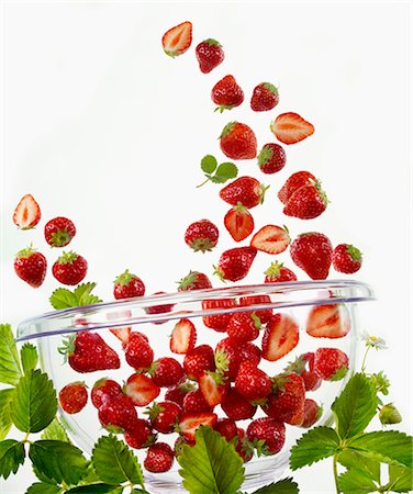 simsearch:659-06186737,k - Many strawberries falling into a glass bowl Foto de stock - Royalty Free Premium, Número: 659-06187547