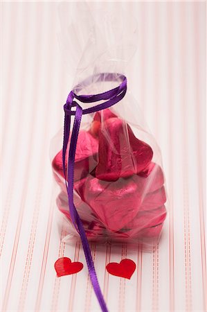 día de la madre - Heart-shaped chocolates wrapped in red foil in a cellophane bag Foto de stock - Sin royalties Premium, Código: 659-06187561