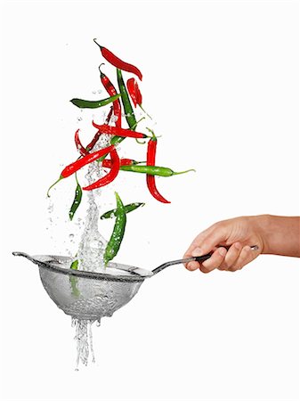 Sieve and airborne chillies Stock Photo - Premium Royalty-Free, Code: 659-06187854