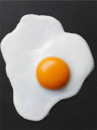 sunny side up - Fried egg on a black background Stock Photo - Premium Royalty-Free, Code: 659-06187870