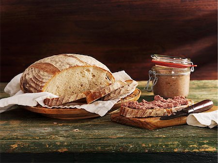 Cut rustic loaf and slice of bread with spread Stock Photo - Premium Royalty-Free, Code: 659-06187885