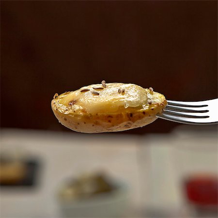 Raclette: half a potato with melted cheese Stock Photo - Premium Royalty-Free, Code: 659-06187896