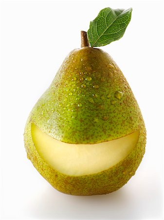 fruits on white background - A green pair with a slice taken out of it Stock Photo - Premium Royalty-Free, Code: 659-06187913