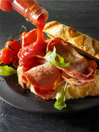 Ketchup being added to a bacon sandwich Stock Photo - Premium Royalty-Free, Code: 659-06187941