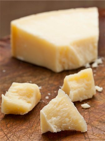 dairy - Grana Padano (hard Italian cheese) on wooden board Stock Photo - Premium Royalty-Free, Code: 659-06187974