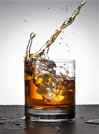 spirits alcohol - Ice cube falling into whisky glass Stock Photo - Premium Royalty-Free, Code: 659-06188025