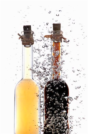 effervescing - Vinegar and oil bottles in water with air bubbles Stock Photo - Premium Royalty-Free, Code: 659-06188034