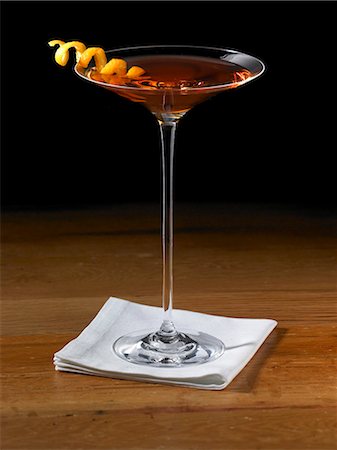 Sorriso Cocktail in a Stem Glass with Orange Peel Twist Garnish Stock Photo - Premium Royalty-Free, Code: 659-06188215