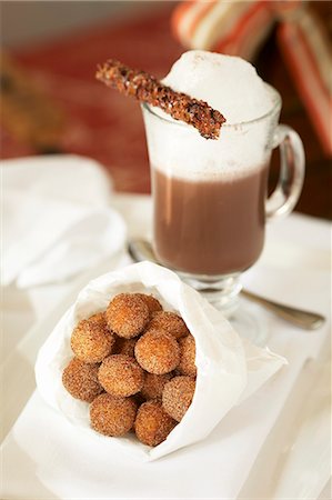 doughnuts and coffee - Paper Bag of Sugared Donut Holes; Cappuccino with Foam Stock Photo - Premium Royalty-Free, Code: 659-06188228