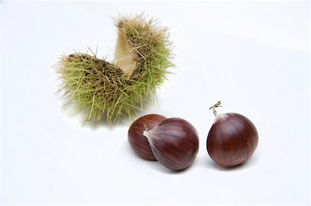 sweet chestnuts - Three chestnuts and open, green chestnut shell Stock Photo - Premium Royalty-Free, Code: 659-06188359