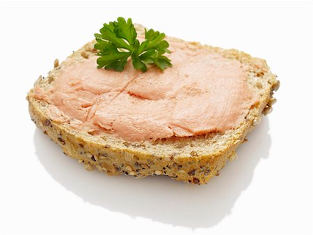 spreading - A slice of bread topped with teewurst Stock Photo - Premium Royalty-Free, Code: 659-06188419